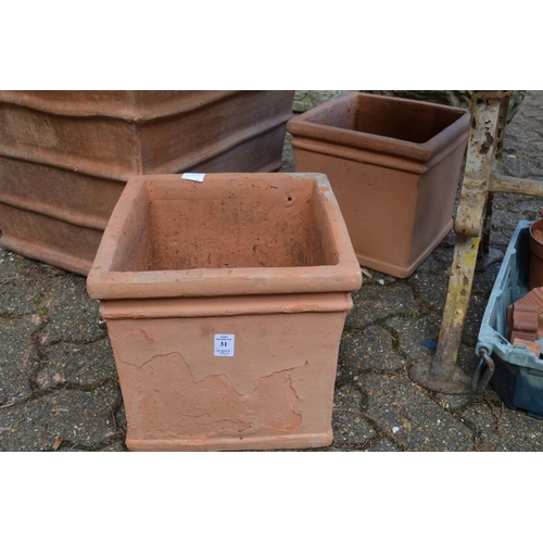 31 - A pair of square shaped terracotta plant pots.