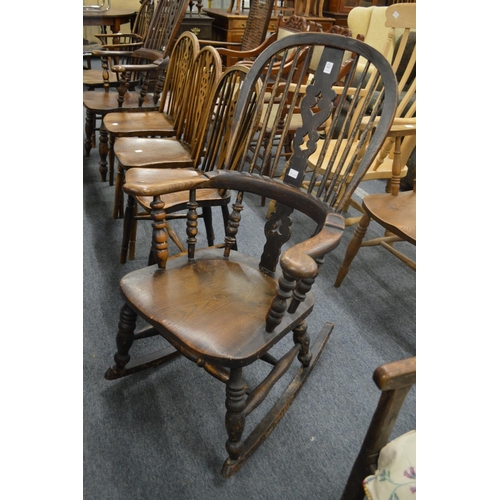 323 - A Victorian beech and elm broad arm rocking chair.