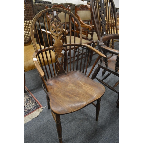 326 - A 19th century ash and elm wheelback Windsor armchair.