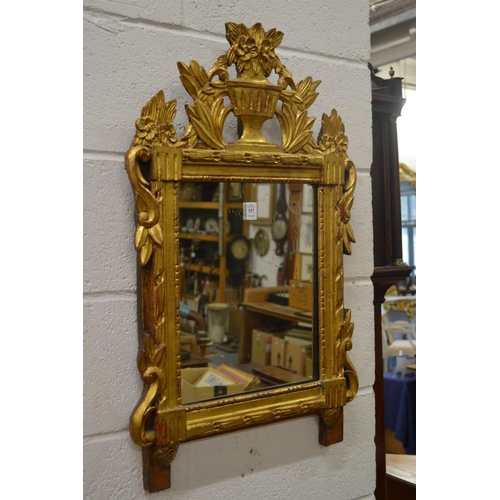 337 - An Italian carved and gilded pier mirror.