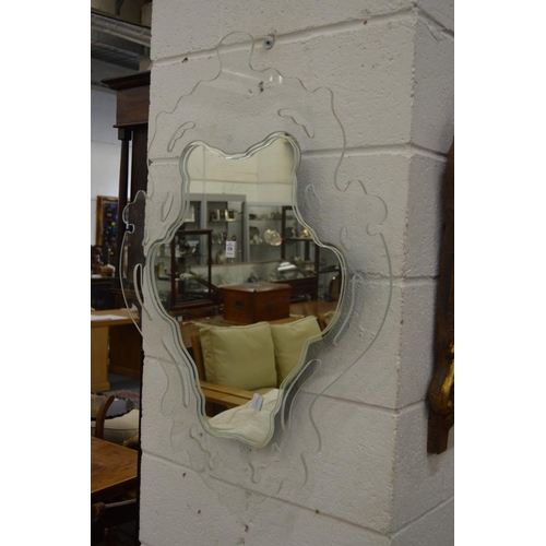 338 - An unusual wall mirror with pierced and shaped glass frame.