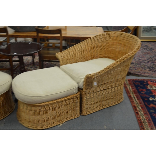 344 - A pair of large wicker armchairs with matching foot stools.