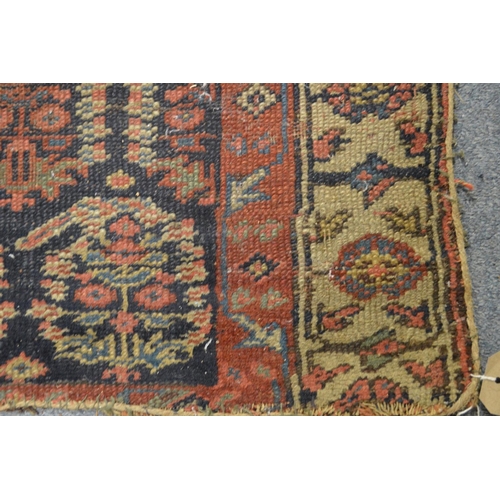 355 - A Persian runner or hall carpet, dark blue ground with stylised Boteh decoration, ends reduced 300cm... 