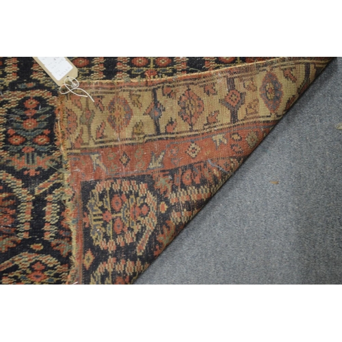 355 - A Persian runner or hall carpet, dark blue ground with stylised Boteh decoration, ends reduced 300cm... 