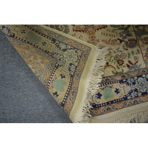 359 - A Persian carpet, cream ground with stylised decoration 219cm x 138cm.