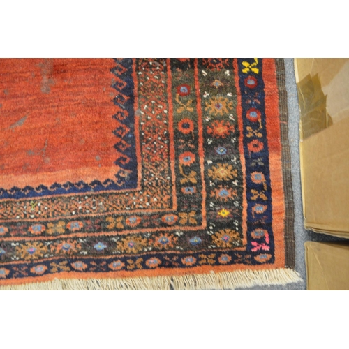 360 - A Persian design rug, red ground with two large central medallions 158cm x 128cm.