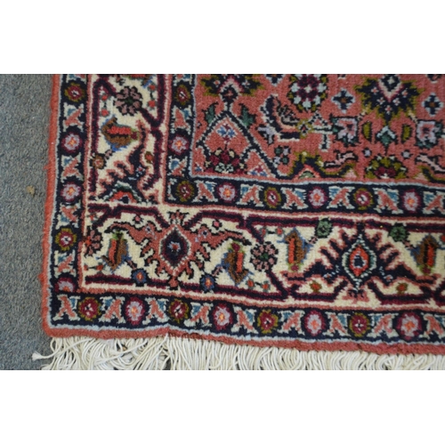 365 - A small Persian rug with stylised decoration.