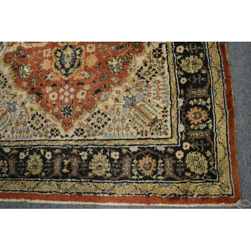 370 - A Persian part silk rug with stylised floral decoration 135cm x 81cm.