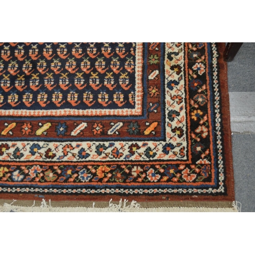 373 - A Persian runner or hall carpet, decorated with stylised Boteh design 450cm x 110cm.