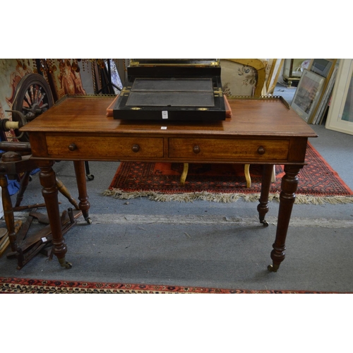 389 - Gillows of Lancaster, a good mahogany two drawer writing table.