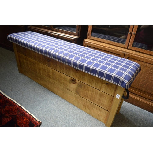 403 - A pair of rustic pine and upholstered long stools.