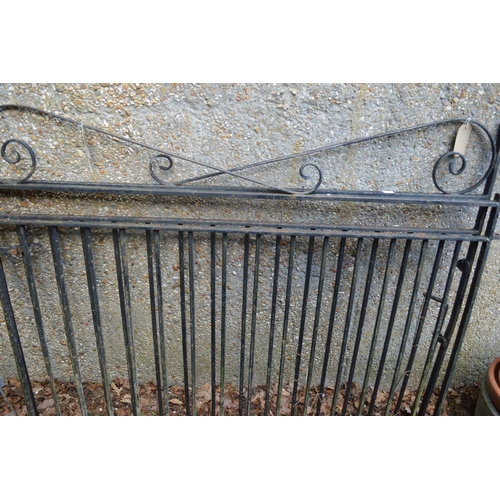 51 - A pair of black painted wrought iron driveway gates each measuring 120cm high x 153cm wide.