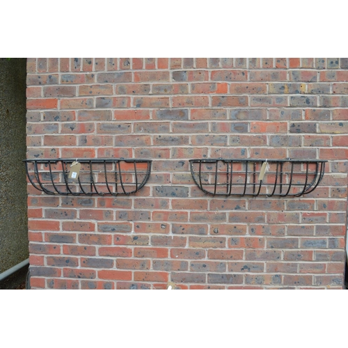 55 - A pair of wrought iron wall planters.