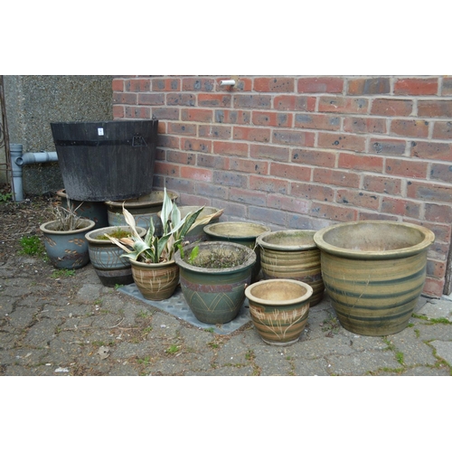 56 - A quantity of glazed plant pots and a barrel shaped tub.