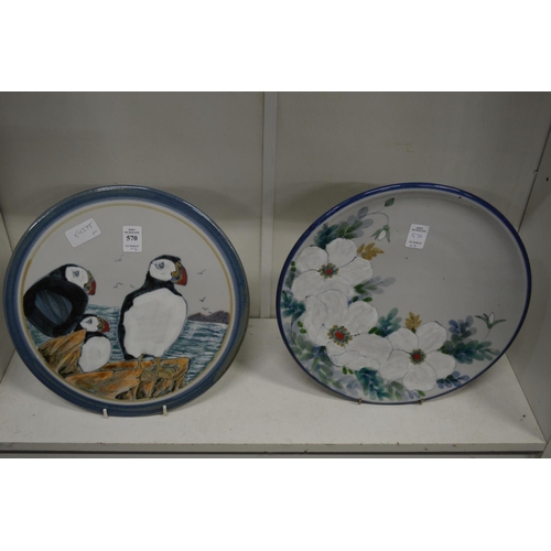 570 - A Highland stoneware plaque painted with puffins together with a similar plate and two Sarah Akin-Sm... 