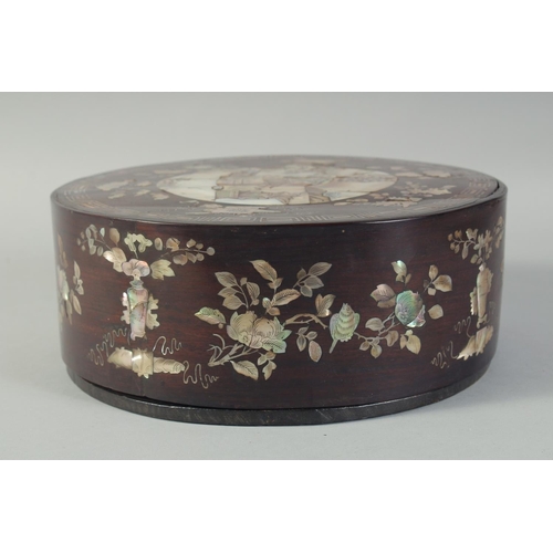 116 - A CHINESE MOTHER OF PEARL INLAID CIRCULAR BOX AND COVER, with a central panel depicting a scene with... 