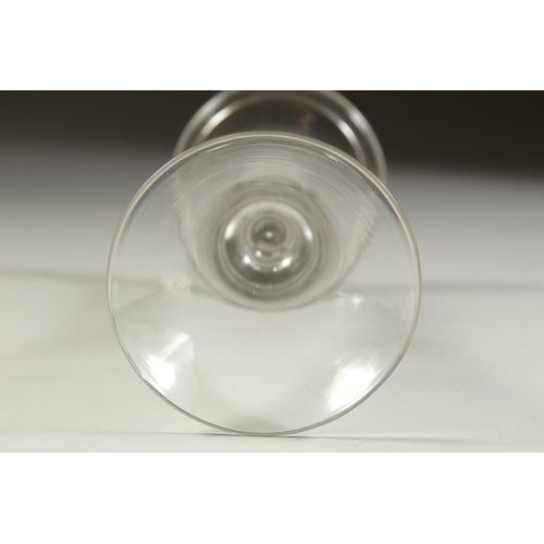 1067 - AN 18TH CENTURY ENGLISH WINE GLASS with tapering bowl. 6.5ins high.