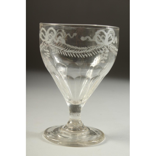 1069 - AN 18TH CENTURY IRISH GLASS RUMMER engraved with ribbon motif and garland. 5ins high.