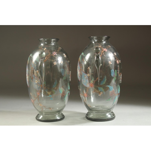 1099 - A GOOD PAIR OF ART DECO GLASS VASES with enamel decoration. 7ins high.