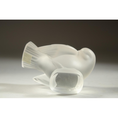 1102 - A LALIQUE FROSTED GLASS BIRD. Etched Lalique, France and Crystal Lalique label. 4ins high.