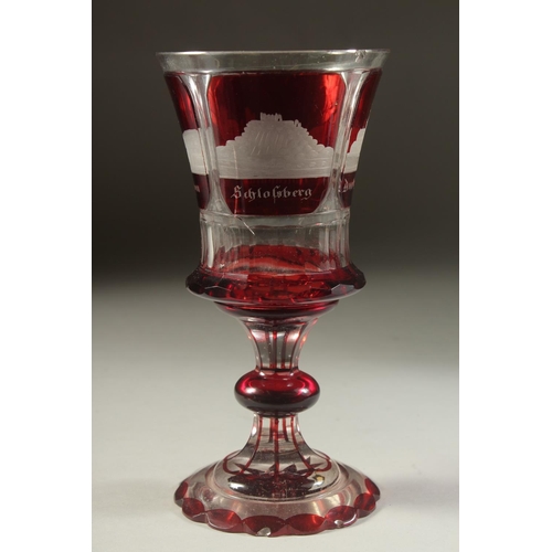 1106 - A GOOD BOHEMIAN RUBY GOBLET etched with four buildings. 8ins high and A PAIR OF BEAKERS 4ins high. (... 