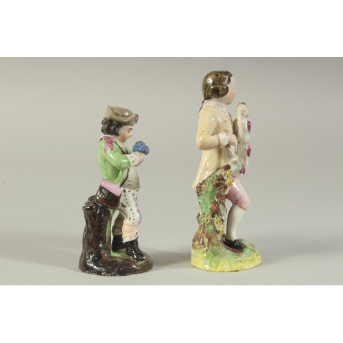 1147 - A STAFFORDSHIRE FIGURE OF A BOY AND A CONTINENTAL FIGURE OF A BOY both carrying grapes (2). 5.5ins x... 