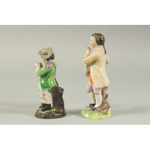 1147 - A STAFFORDSHIRE FIGURE OF A BOY AND A CONTINENTAL FIGURE OF A BOY both carrying grapes (2). 5.5ins x... 