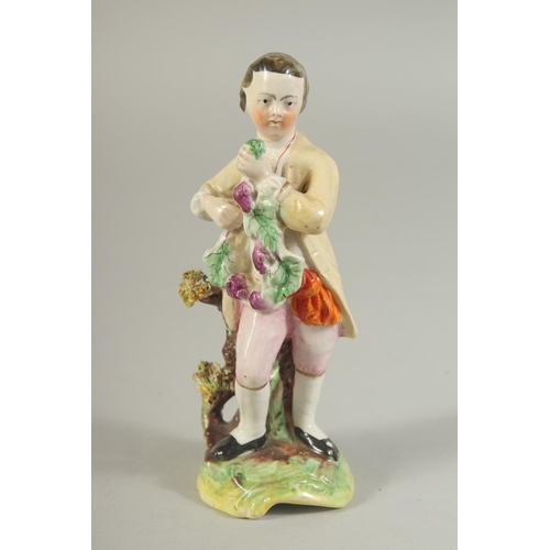 1147 - A STAFFORDSHIRE FIGURE OF A BOY AND A CONTINENTAL FIGURE OF A BOY both carrying grapes (2). 5.5ins x... 