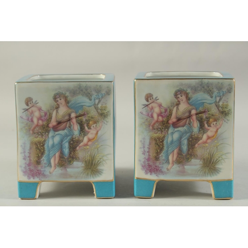 1156 - A PAIR OF BLUE SEVRES DESIGN SQUARE CACHES POTS with classical design panel. 7ins high.