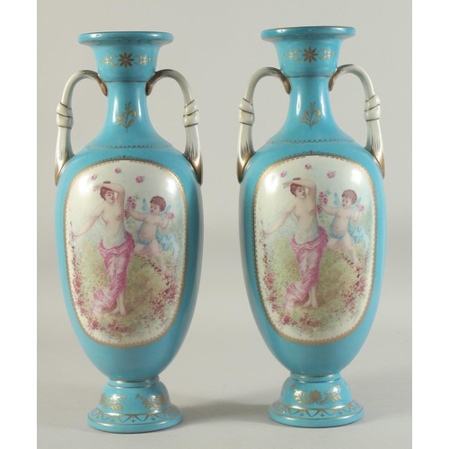 1157 - A PAIR OF BLUE SEVRES DESIGN TWO HANDLED VASES with panels of cupids.