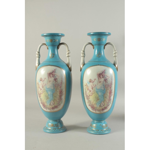 1157 - A PAIR OF BLUE SEVRES DESIGN TWO HANDLED VASES with panels of cupids.