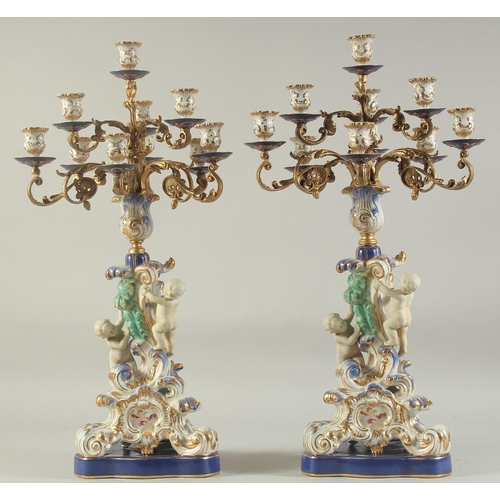 1158 - A GOOD PAIR OF SEVRES DESIGN PORCELAIN TEN LIGHT CANDELABRA with gilt metal branches, the base with ... 