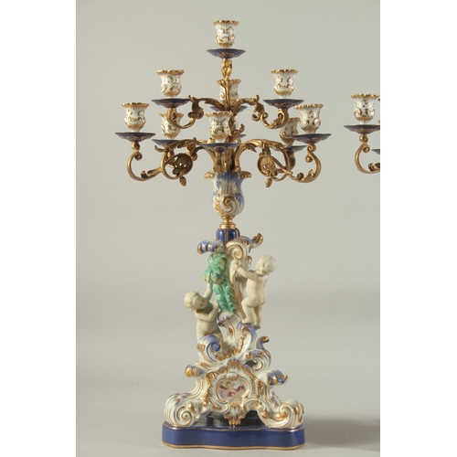 1158 - A GOOD PAIR OF SEVRES DESIGN PORCELAIN TEN LIGHT CANDELABRA with gilt metal branches, the base with ... 