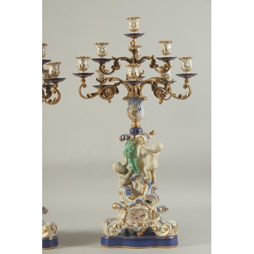 1158 - A GOOD PAIR OF SEVRES DESIGN PORCELAIN TEN LIGHT CANDELABRA with gilt metal branches, the base with ... 