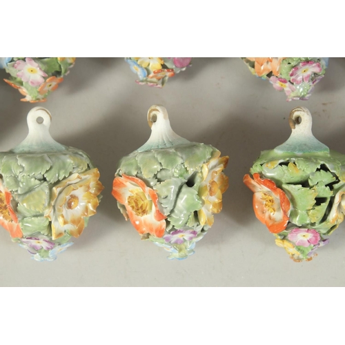 1164 - A GOOD SET OF NINE MEISSEN PORCELAIN FLOWER ENCRUSTED TREE DECORATIONS. 2.75ins long.