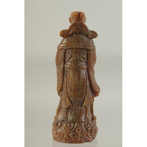 1176 - A CARVED HORN CHINESE DEITY. 8ins high.