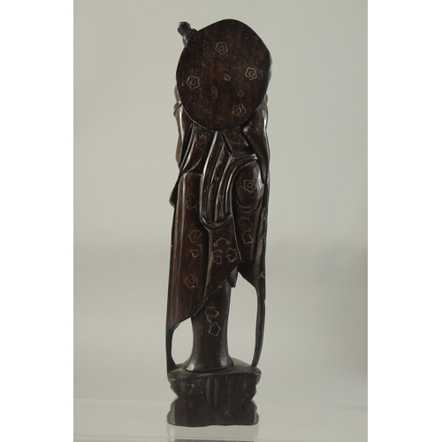 1181 - A CHINESE CARVED AND INLAID WOODEN FIGURE. 11ins high.