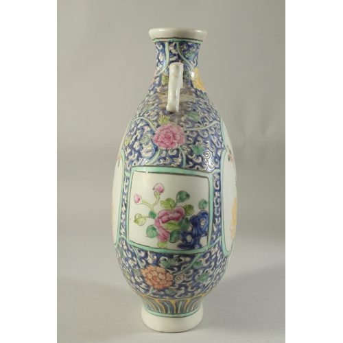 1186 - A CHINESE PORCELAIN MOON FLASK with panels of birds and flowers. 14ins high.