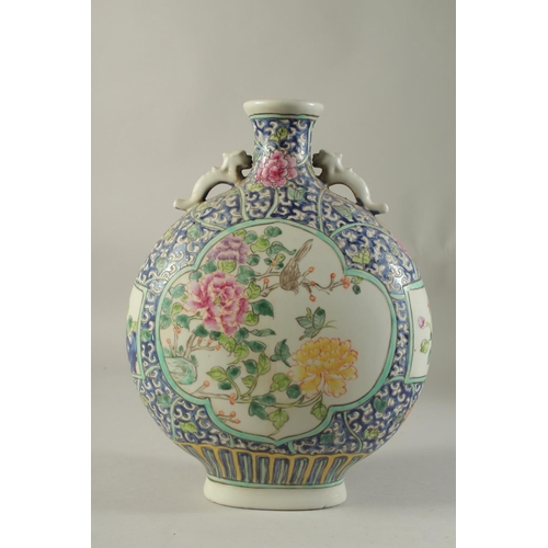 1186 - A CHINESE PORCELAIN MOON FLASK with panels of birds and flowers. 14ins high.