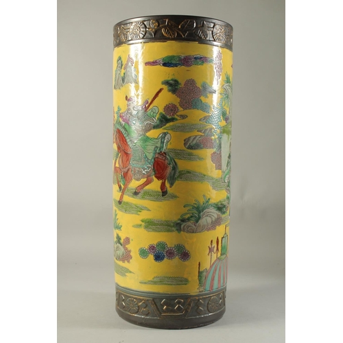 1188 - A CHINESE PORCELAIN YELLOW GROUND STICK STAND. 23ins high.