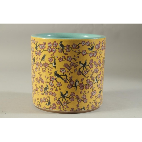 1189 - A CHINESE PORCELAIN YELLOW GROUND BRUSH POT with birds and flowers. 7ins high.