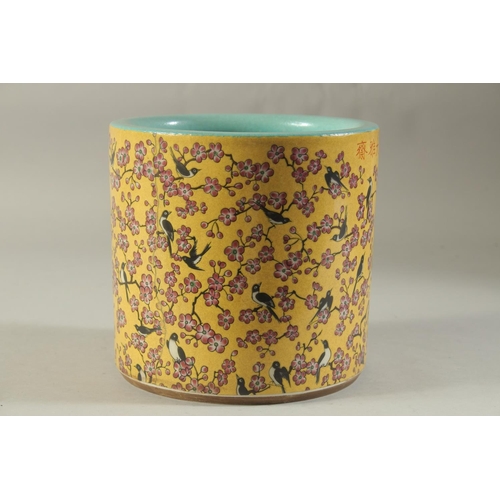 1189 - A CHINESE PORCELAIN YELLOW GROUND BRUSH POT with birds and flowers. 7ins high.