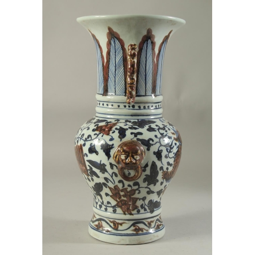 1191 - A CHINESE PORCELAIN BLUE AND RED VASE decorated with dragons. 14ins high.