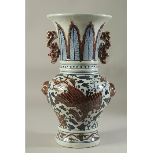 1191 - A CHINESE PORCELAIN BLUE AND RED VASE decorated with dragons. 14ins high.