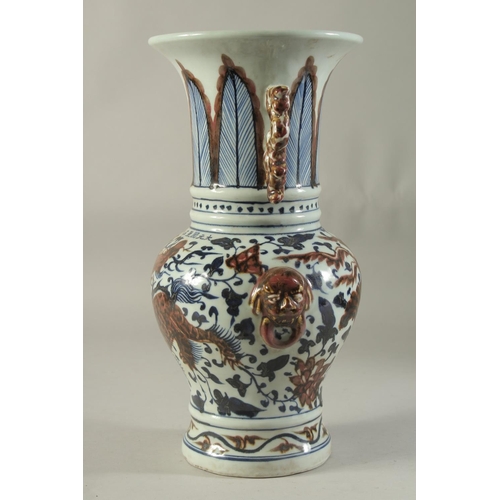 1191 - A CHINESE PORCELAIN BLUE AND RED VASE decorated with dragons. 14ins high.