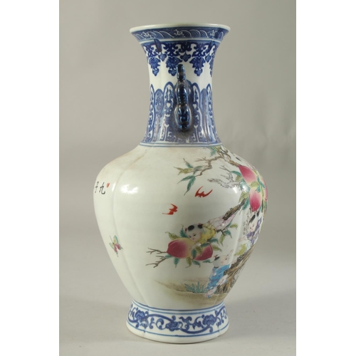 1193 - A CHINESE PORCELAIN VASE painted with children and peaches. 14ins high.