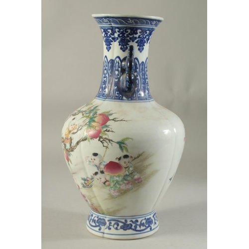 1193 - A CHINESE PORCELAIN VASE painted with children and peaches. 14ins high.