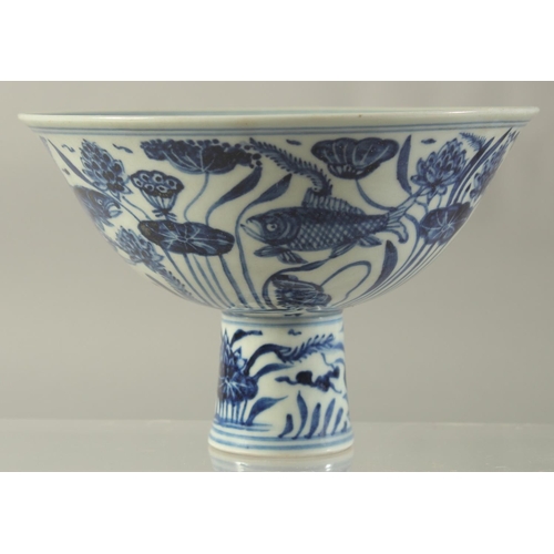 1194 - A CHINESE PORCELAIN BLUE AND WHITE STEM CUP painted with fish. 6.5ins high.