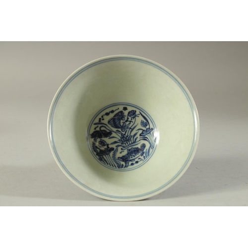 1194 - A CHINESE PORCELAIN BLUE AND WHITE STEM CUP painted with fish. 6.5ins high.