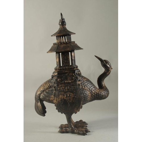 1196 - A CHINESE BRONZE EMU CENSER carrying a temple on its back. 16ins high.